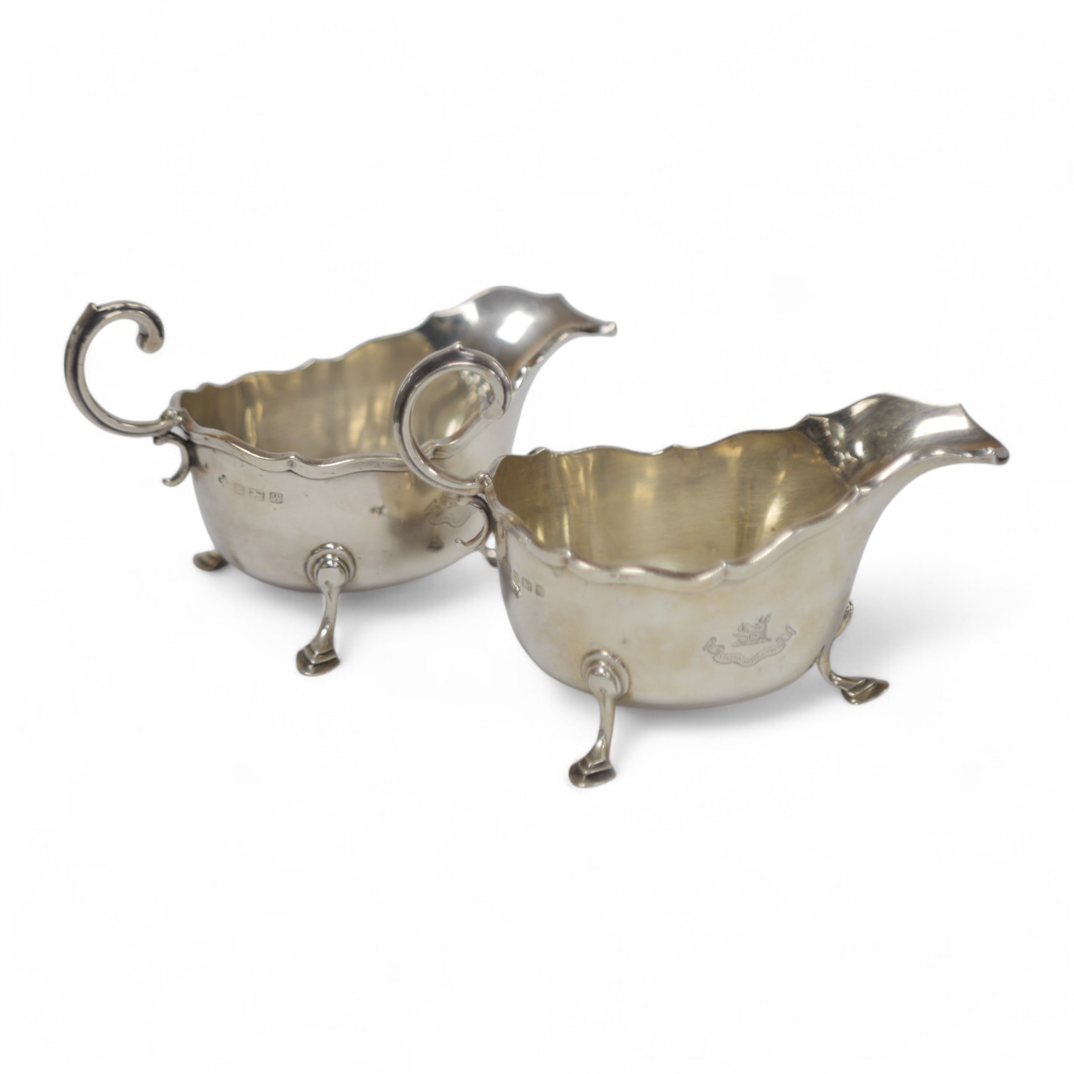 A matched pair of George V silver sauceboats, Horace Woodward & Co Ltd, Birmingham, 1921 and Adie Bros. Birmingham, 1922, 13.3oz. Condition - fair to good